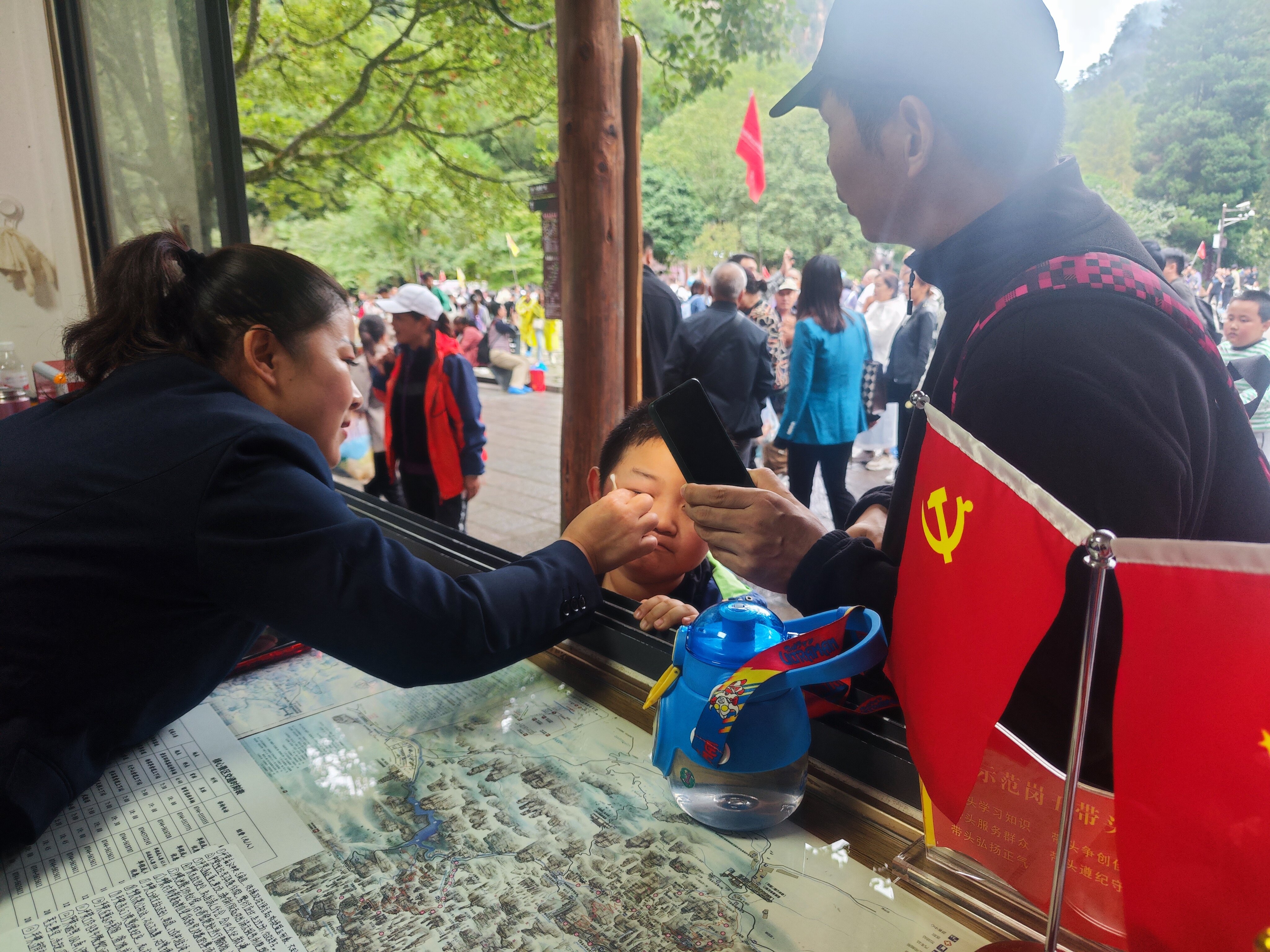 老磨灣黨員義務(wù)咨詢臺黨員為小游客處理被蜜蜂蟄傷傷口。張娜 攝